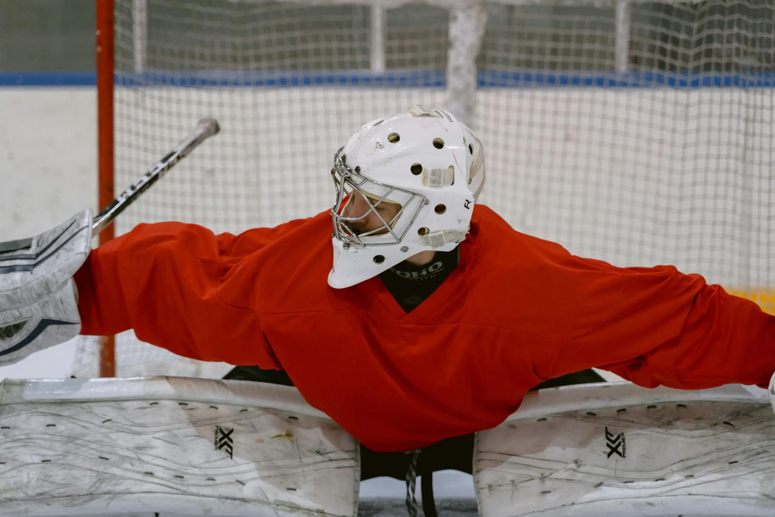 Person in Red Jacket Playing Ice Hockey