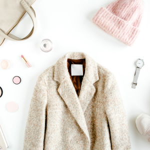 photo of items to wear to an ice hockey rink: Hat, white winter coat, closed shoes and purse