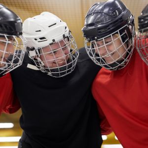 Two children smiling playing Ice Hockey 