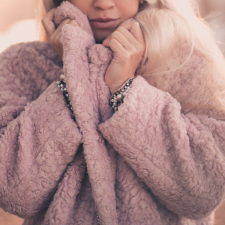 Blonde Ice Hockey Mom with plush soft pink coat