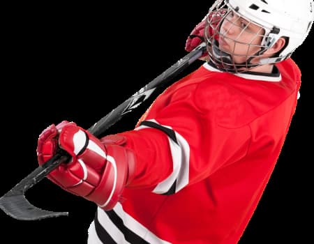 Ice Hockey player in red jersey.  Holding stick in preparation for penalty shot