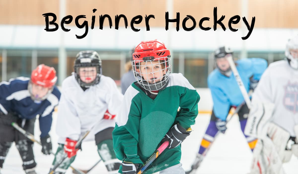 Young kids learning to play beginner hockey with beginner equipment