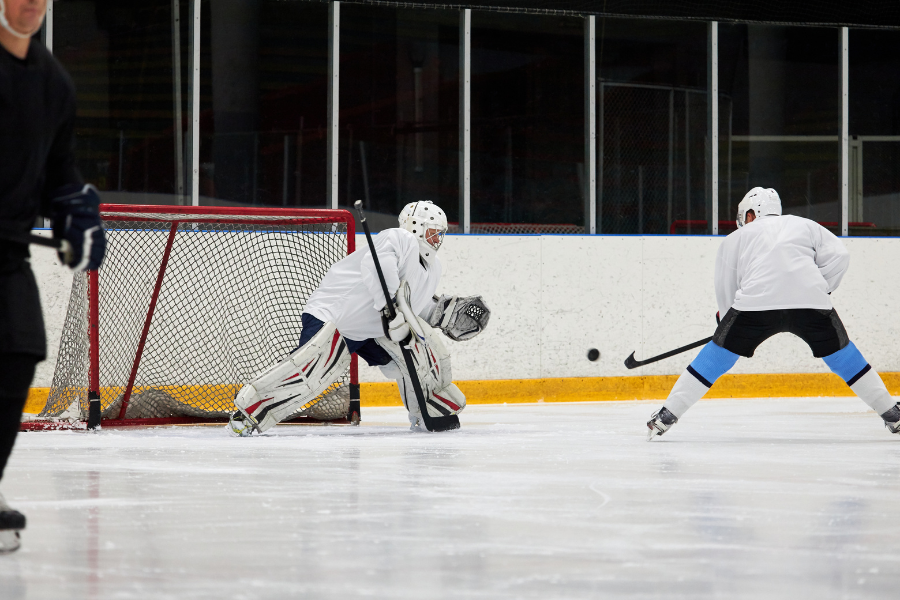 Offensive player taking a shot on a goalie