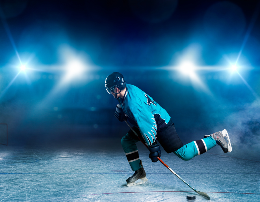 Ice hockey player skating fast with puck and stick.  Demonstrating why hockey shifts are short