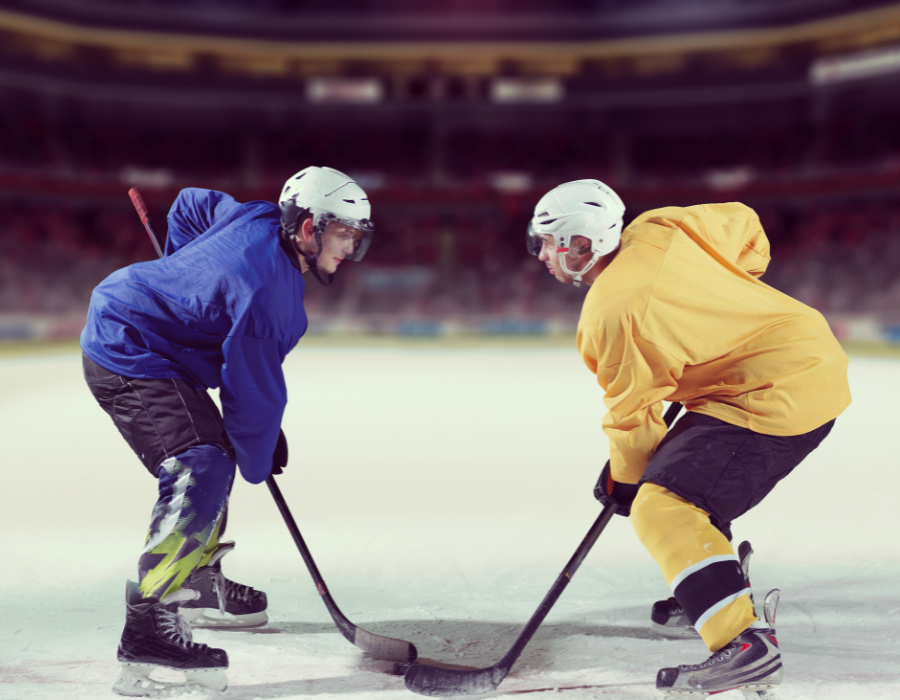 Two ice hockey players at a face off at the start of their short shift