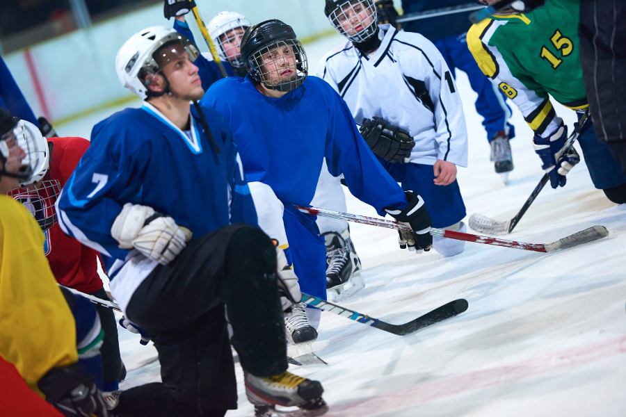 Hockey team preparing with a trainer on ice