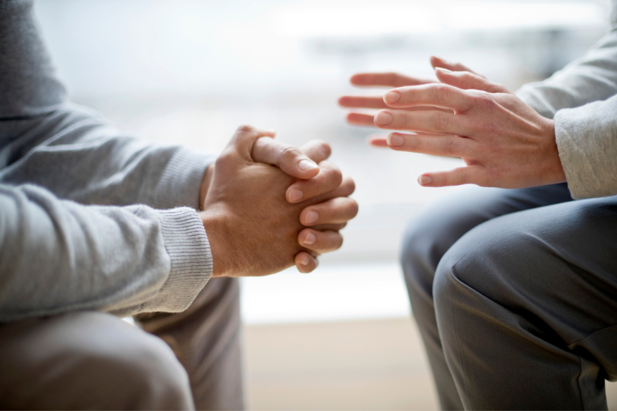 picture shoiwng hands of two people talking