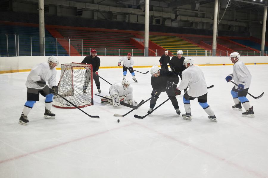 two teams near goalie making an assist or apple before goal