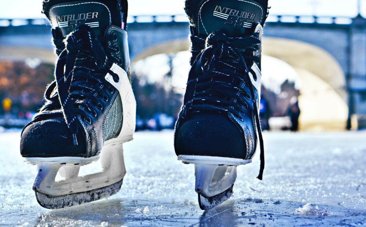 photo of pair of ice skates on ice