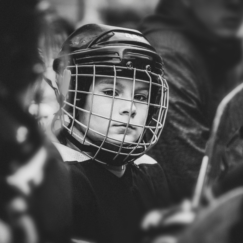 Young ice hockey player in black and white picture with helmet