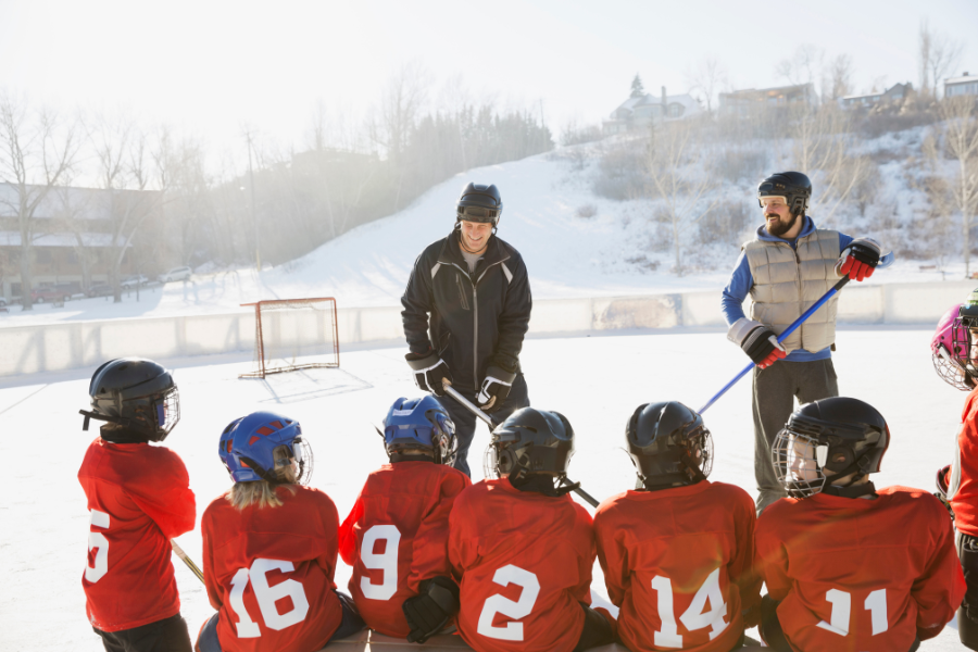 coaches on outside ice with youth ice hockey